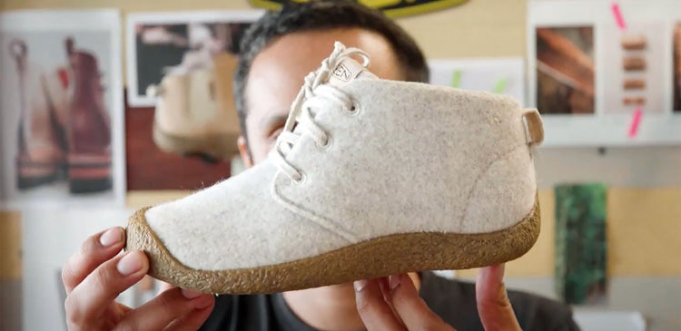 A KEEN designer holds up the new Mosey chukka