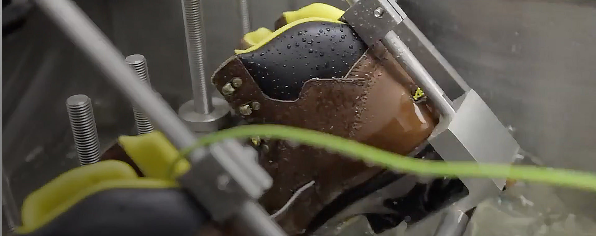 Work boot being tested in Ice by machine
