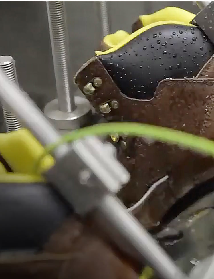 Work boot being tested in Ice by machine