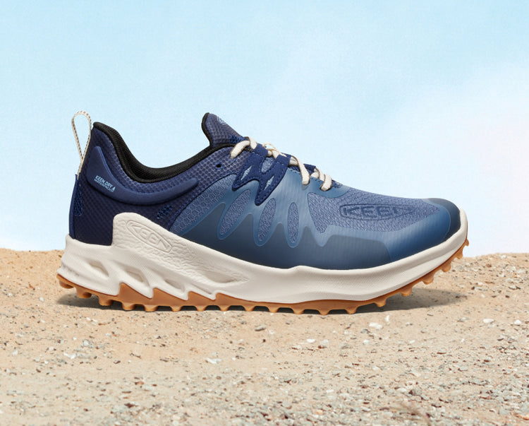 Product shot of men's navy blue and white Zionic waterproof hiking shoe. 