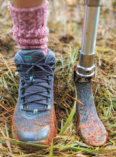 A terradora hiking boot and a prosthetic foot standing in grass