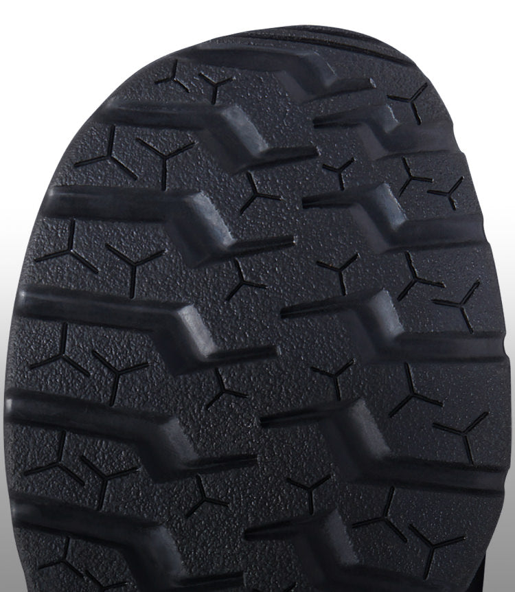 A close-up of the black undersole of a KEEN shoe.