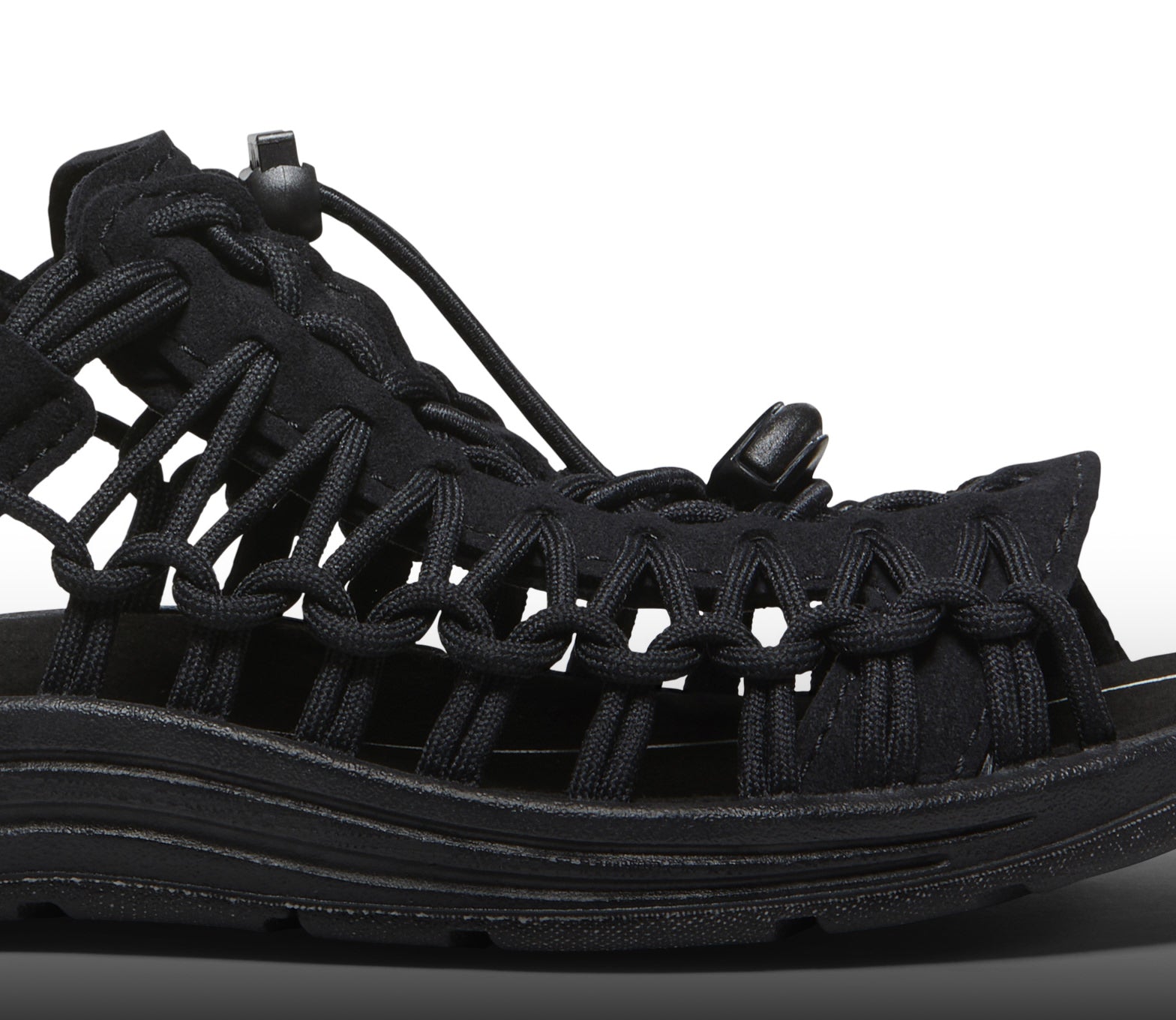 A close-up the side of a black KEEN UNEEK sandal.