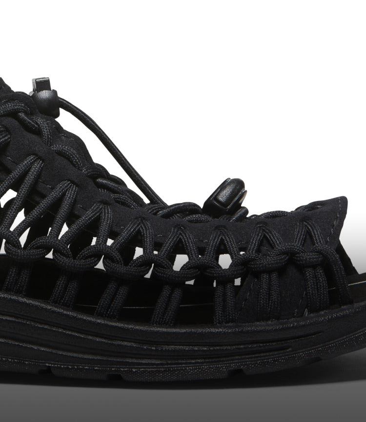 A close-up of the front of a black KEEN UNEEK sandal.
