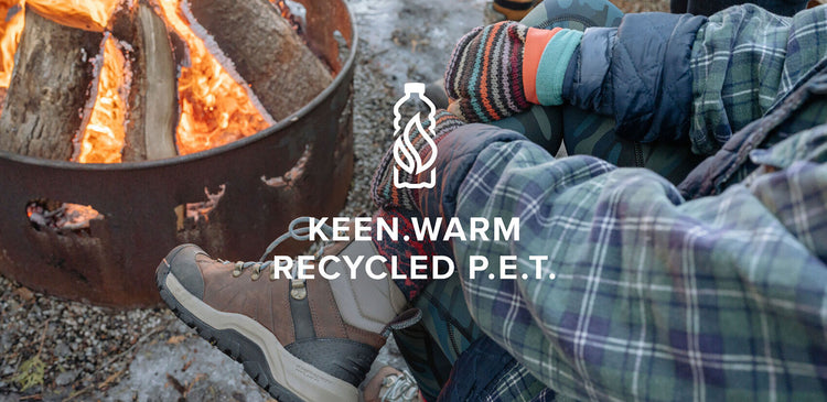 Sitting by a firepit in winter boots with KEEN.WARM Recycled P.E.T.