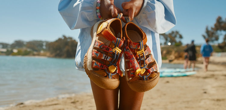 A child holding sandals