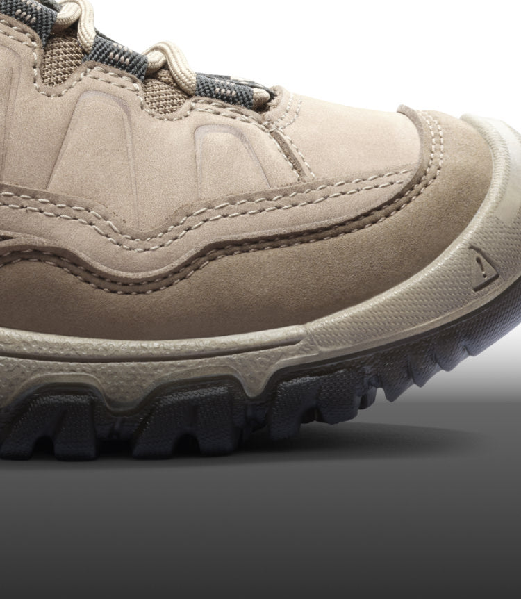 A close-up of the front of a black and light pink KEEN Targhee boot.