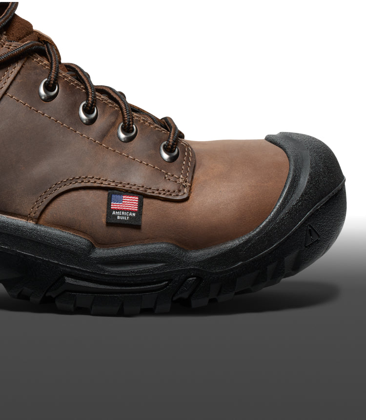 A close-up of the sole/front of a black brown KEEN work boot.