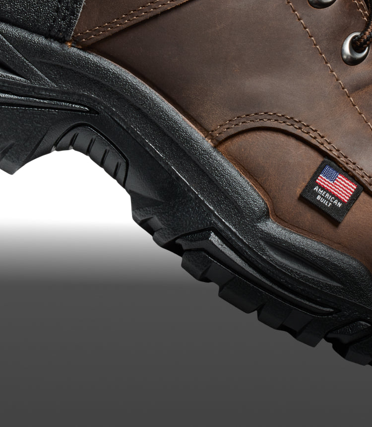 A brown and black KEEN work boot, with a small American Built tag.