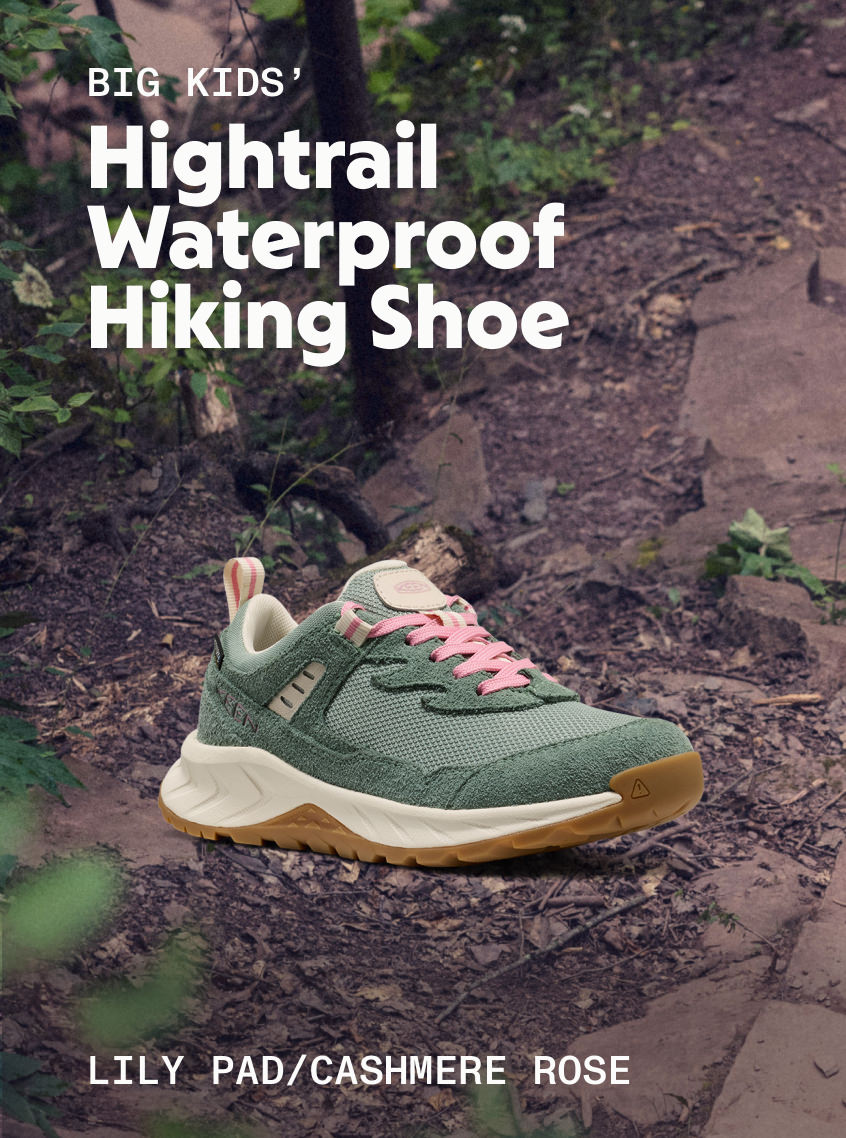 Product shot of Big Kids' Hightrail Waterproof Hiking Shoe in Lily Pad and Cashmere Rose against rocky trail.