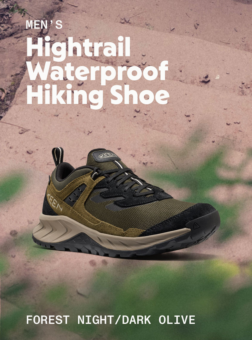 Product shot of Men's Hightrail Waterproof Hiking Shoe in Forest Night and Dark Olive against dirt trail.