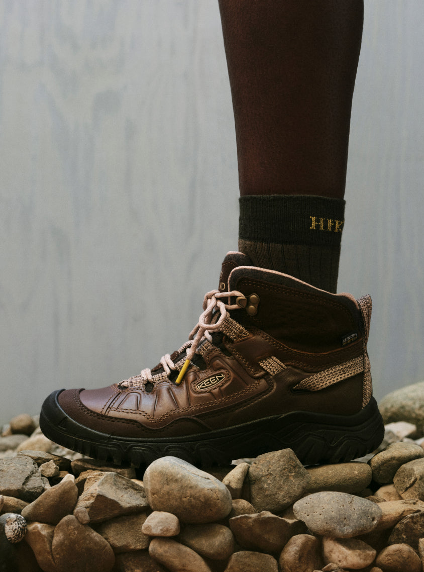 Knee-down shot of woman wearing Hikerkind and Keen collaboration brown leather  hiking boots