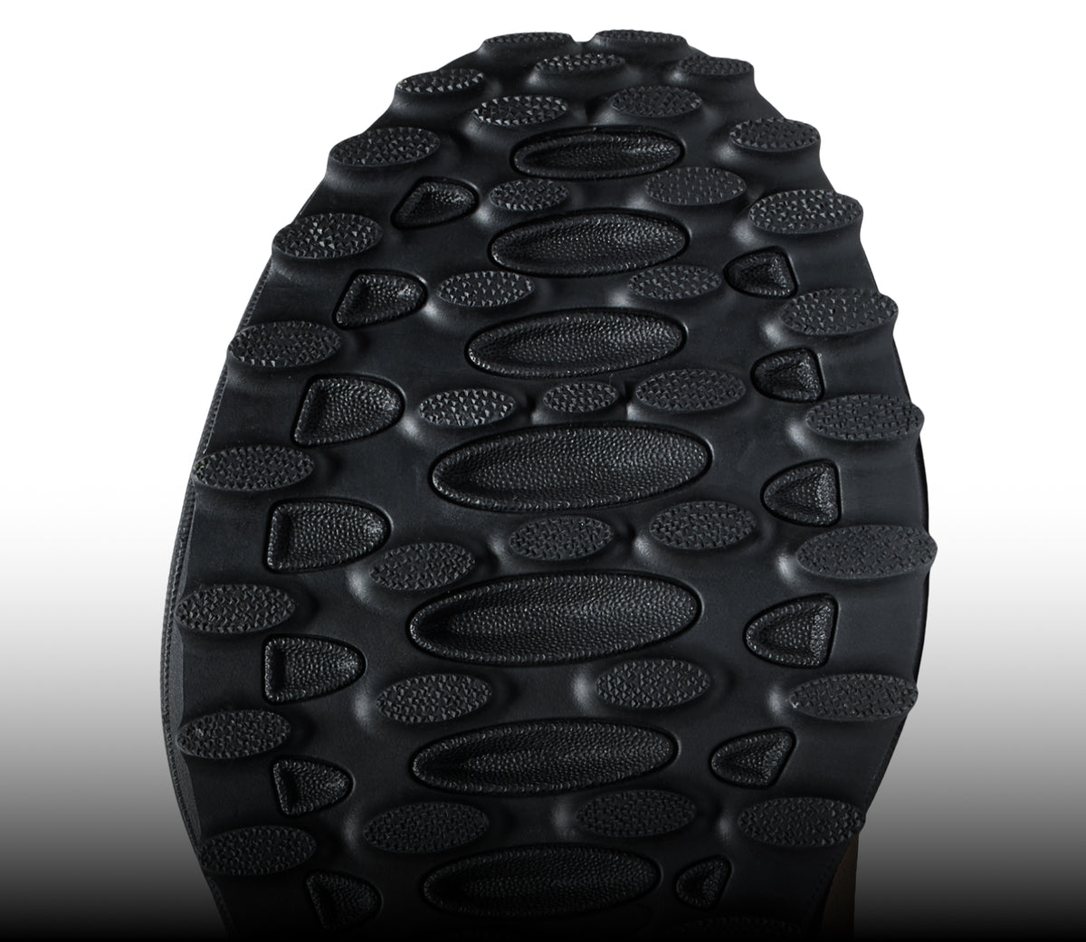 The underside of a KEEN shoe, displaying a black sole with good traction.