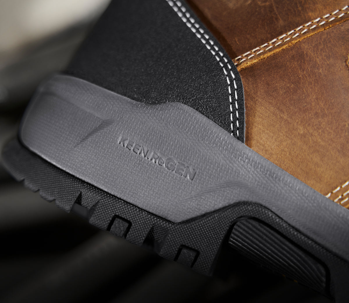 A close-up of the sole of a KEEN work boot, featuring Re.GEN technology.