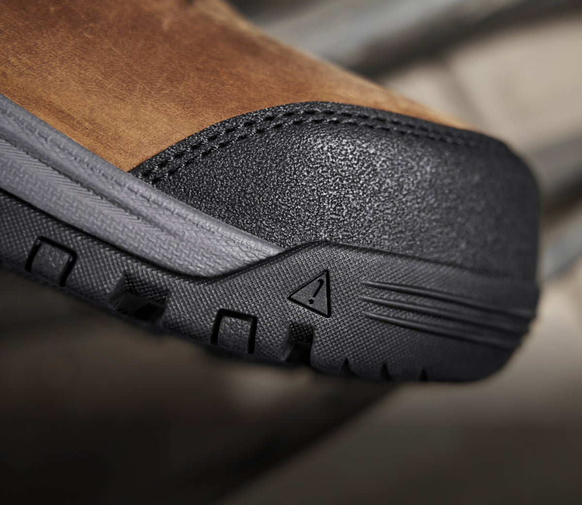 A close-up of the toe of a brown and black KEEN work boot.