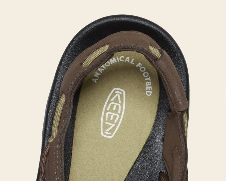 Close-up product shot of the anatomical footbed in the olive green and brown men's Uneek Sandal 