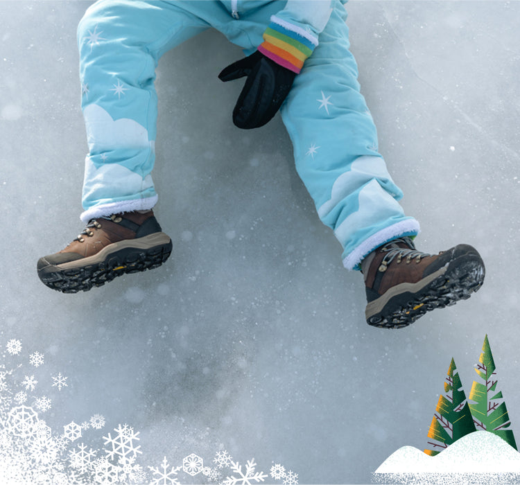 Waist down shot of kid sitting on ice weraring Kid's waterproof boot