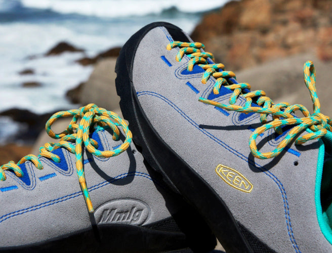 Close-up product shot of MMLG and KEEN collaboration sneakers in gray, blue and yellow