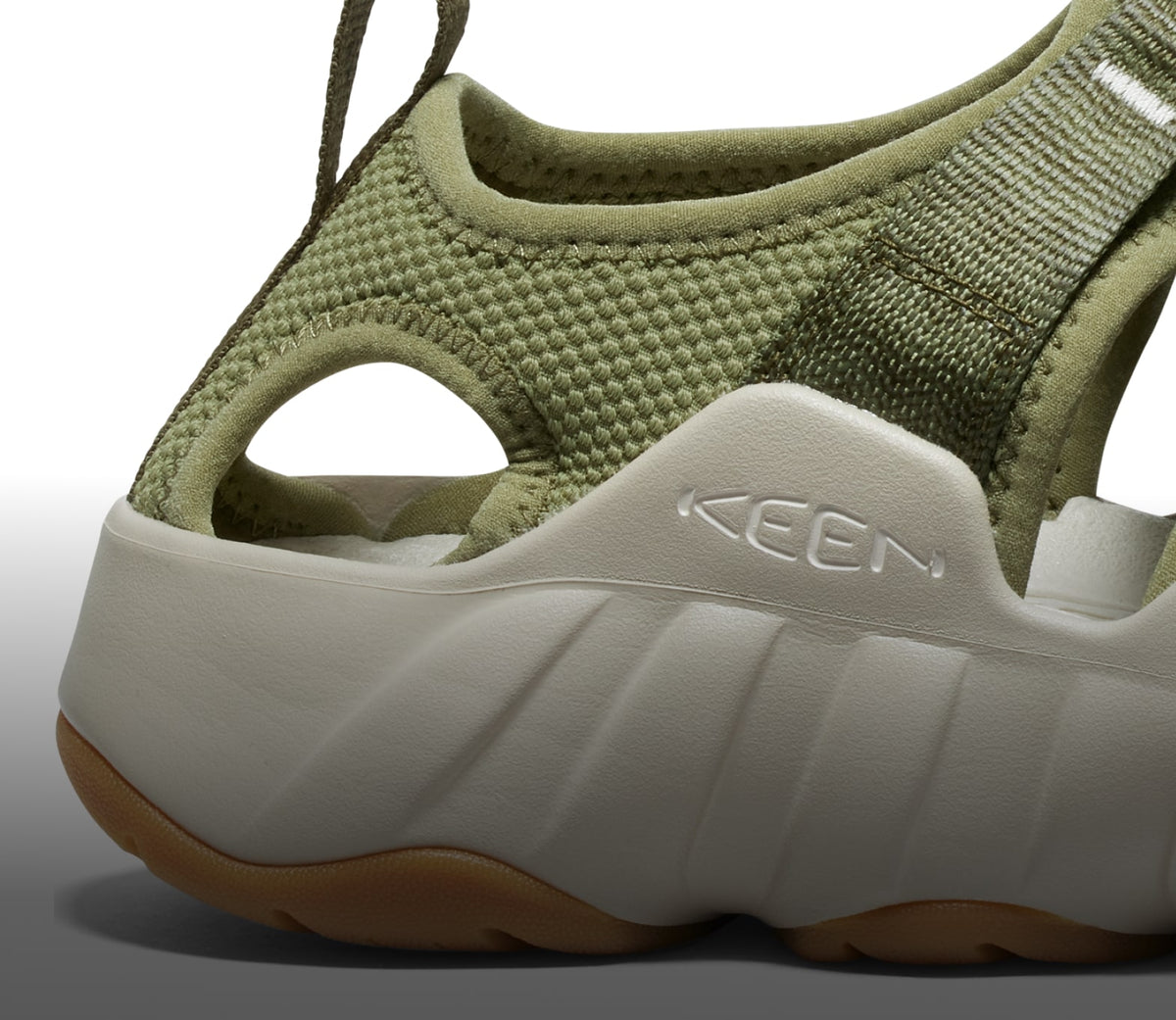A close-up of the white sole of an olive green Hyperport H2 sandal.