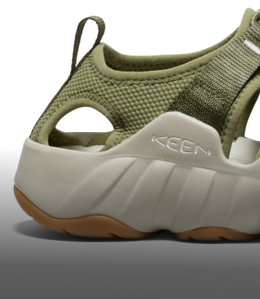 A close-up of the white sole of a pair of olive green Hyperport H2 sandals.