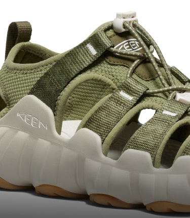 A close-up of the white sole of an olive green Hyperport H2 sandal.
