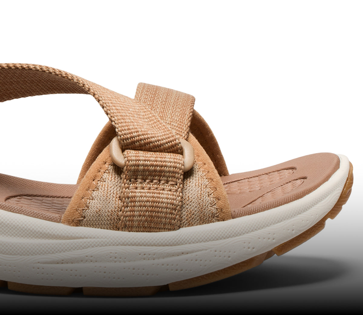A close-up of a white and brown KEEN sandal.