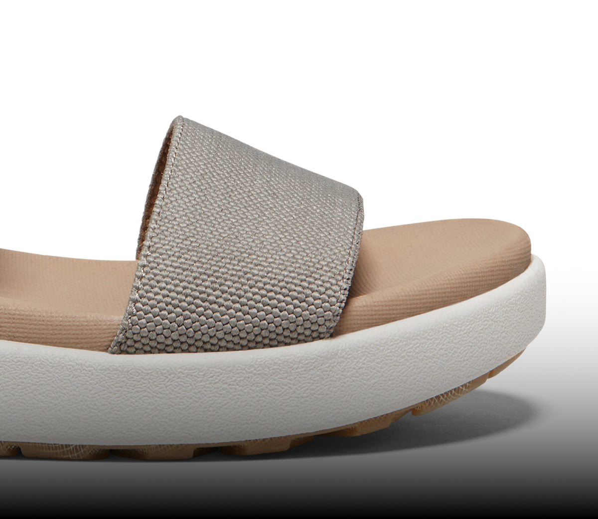 A close-up of the front strap of an Elle sandal.