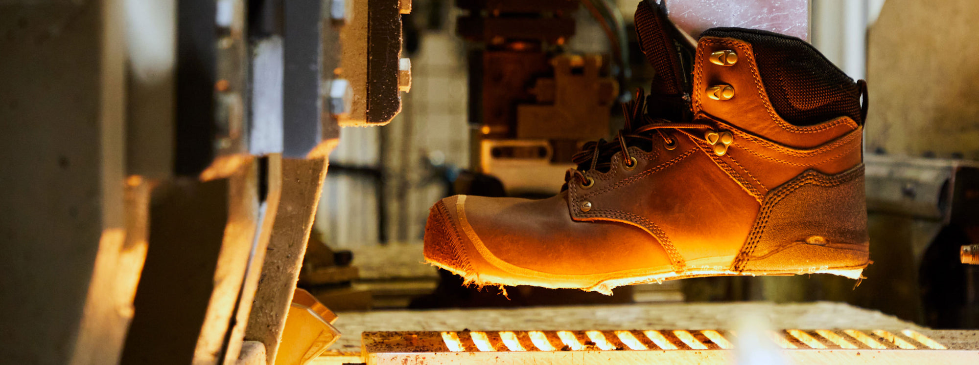 A brown KEEN work-boot in the factory getting prepared for the Keen.Fusion process of attaching the sole. 