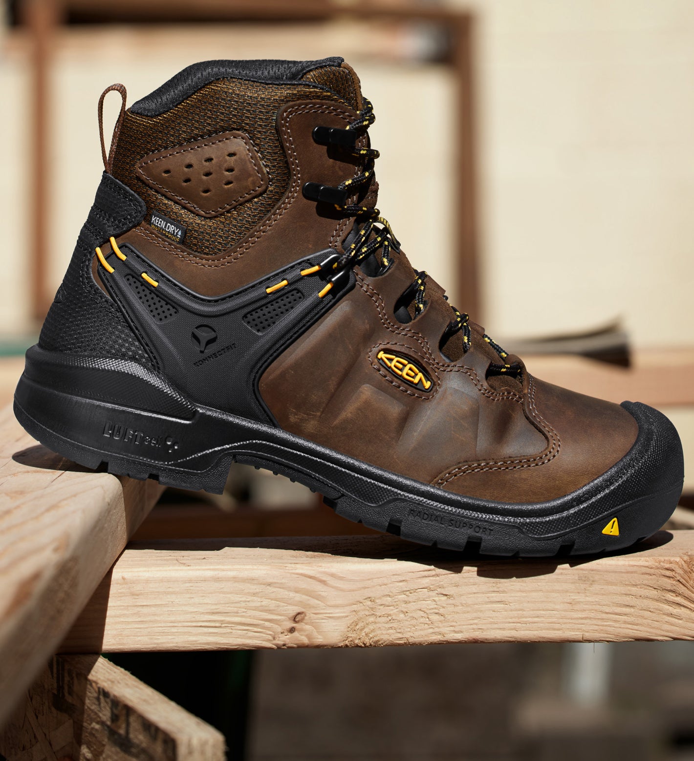 Product shot of men's Dover work-boot resting on wood planks.
