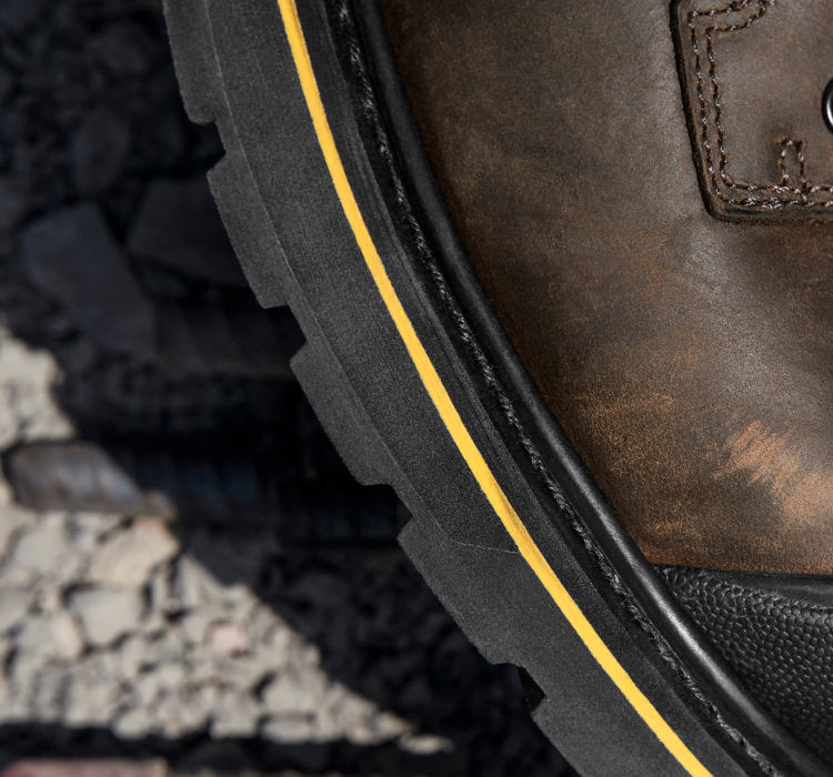 A close-up of the sole of a brown KEEN work boot.