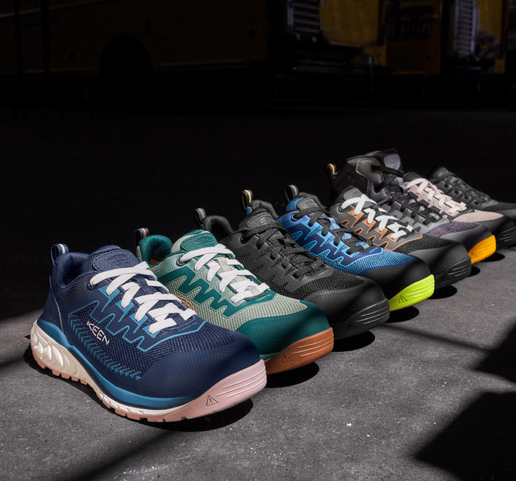 A line of various, different colored KEEN work sneakers.