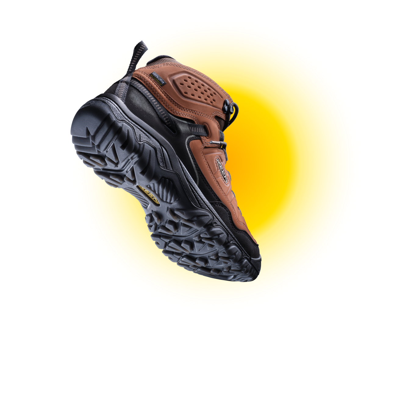 Closeup product shot of men's Targhee leather brown and black hiking boot  with yellow background