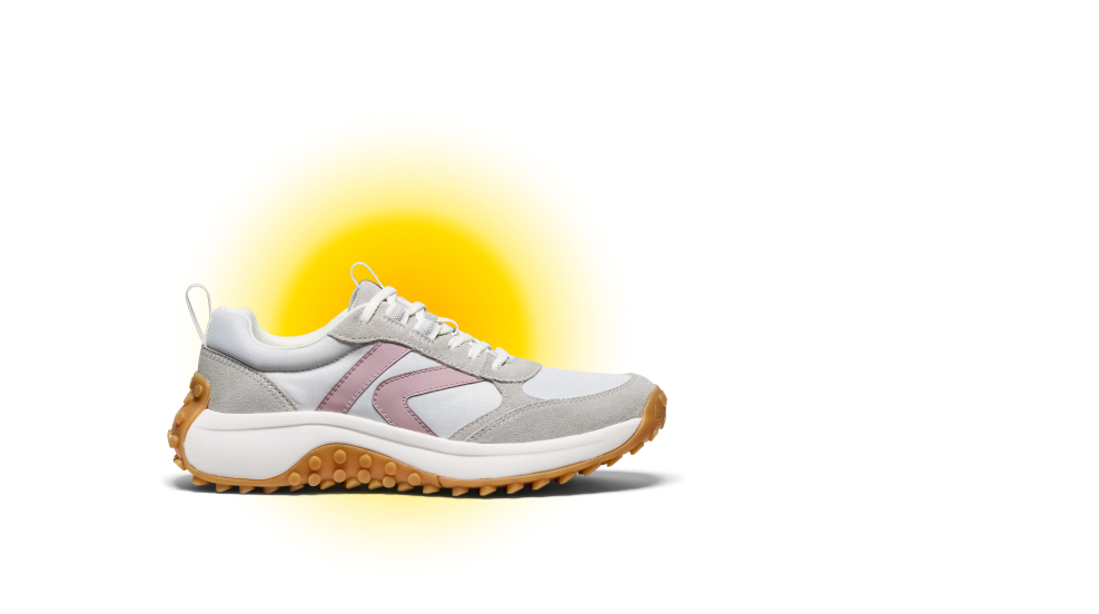 Close up product shot of women's white, grey and pink KS86 leather sneaker with yellow gradient background