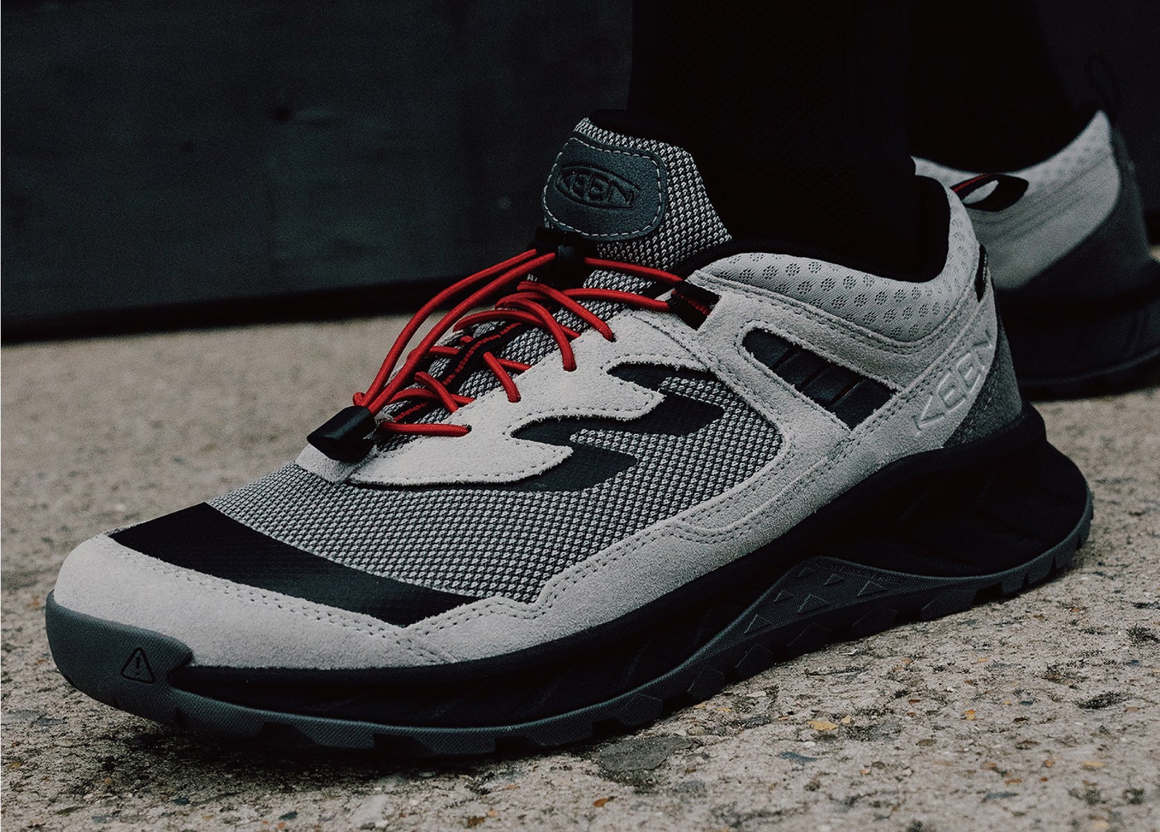 Product shot of Bal and Keen collaboration Hightrail shoe showcasing red bungee laces. 
