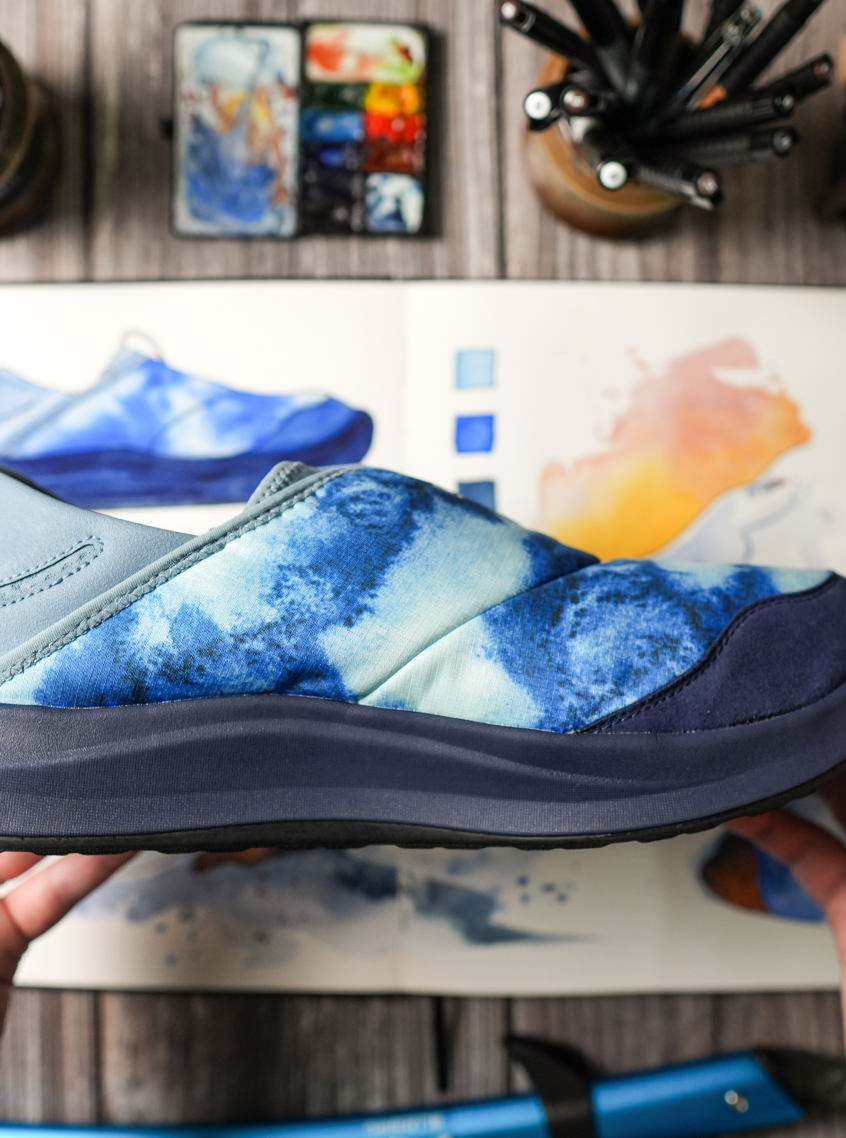 Close up of men's collaboration Whyser shoes that showcase the blue cushion sole and blue gradient design