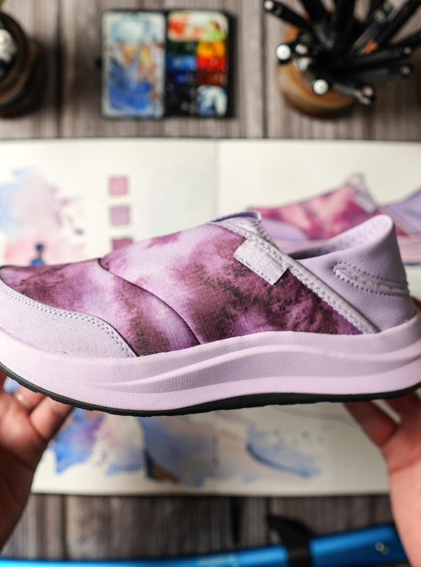 Close up of women's collaboration Whyser shoes that showcase the pink cushion sole and pink gradient design