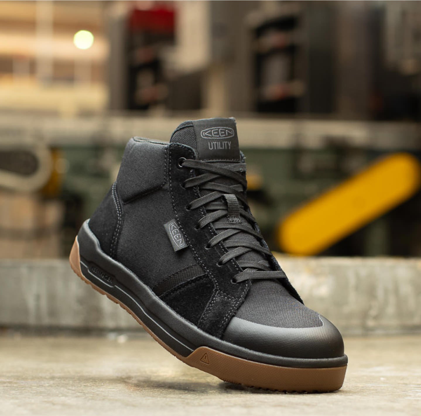 Product shot of men's black work sneaker in warehouse setting