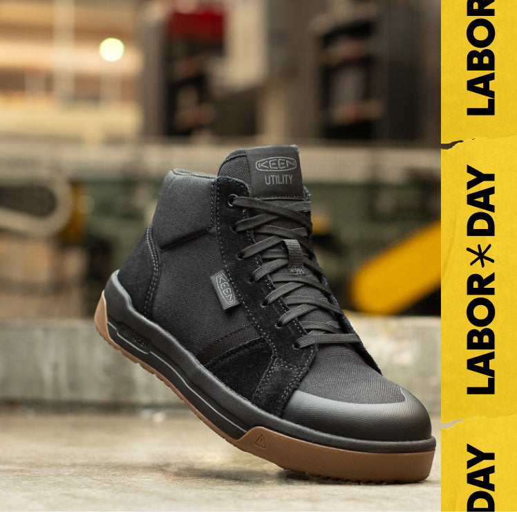 Product shot of men's black work sneaker in warehouse setting. Embedded text reads "Labor Day" in yellow.