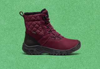 Product shot of maroon and black women's winter boots, featuring insulation and a rugged sole for winter weather protection.