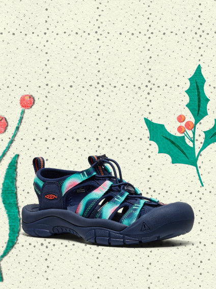 Product shot of navy blue and turquoise hiking and water-sandal with toe protection overlayed on vintage holiday wrapping paper.