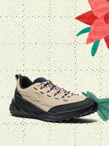 Product shot of tan casual sneaker with pink laces showcasing it's tough hiking tread overlayed on vintage holiday wrapping paper.