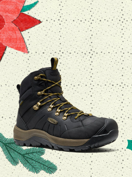Product shot of a black leather heavy duty and waterproof hiking boot with mustard yellow laces overlayed on vintage holiday wrapping paper.