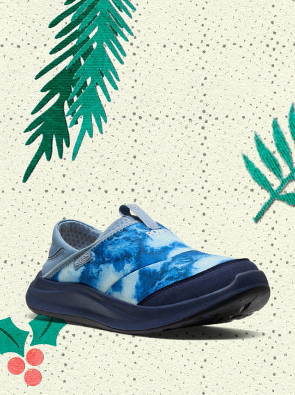 Product shot of a slip-on sneaker with unique blue gradient design overlayed on vintage holiday wrapping paper.