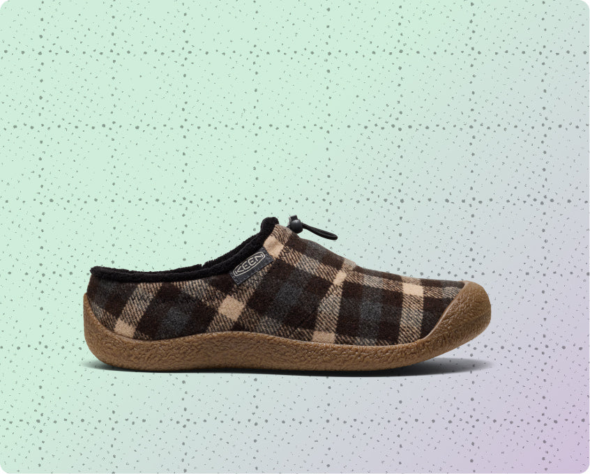 Women's brown and tan plaid slip-on Howser on a dotted grid wrapping-paper background.