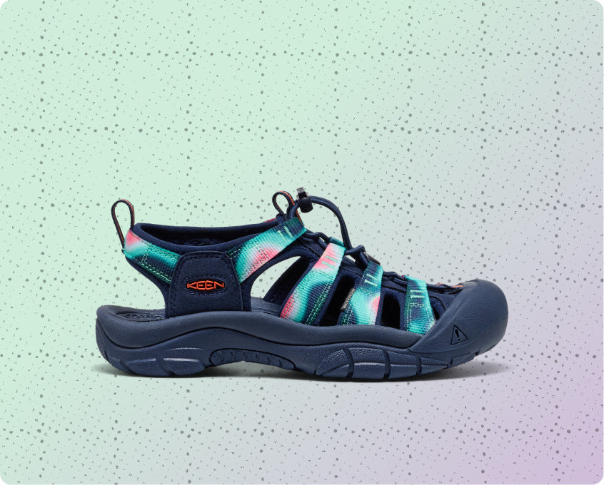 Womens navy blue and tie-dye Newport water sandal on a dotted grid wrapping-paper background.