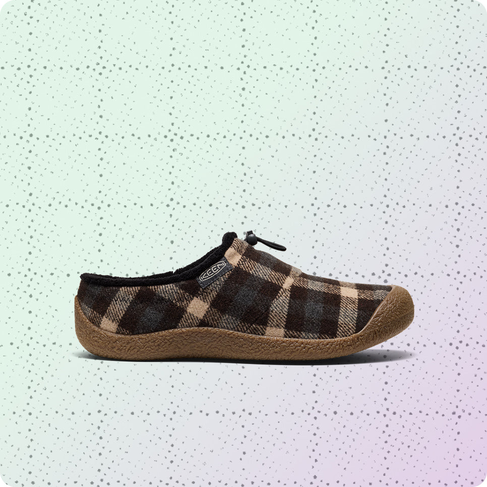Women's brown and tan plaid slip-on Howser on a dotted grid wrapping-paper background.