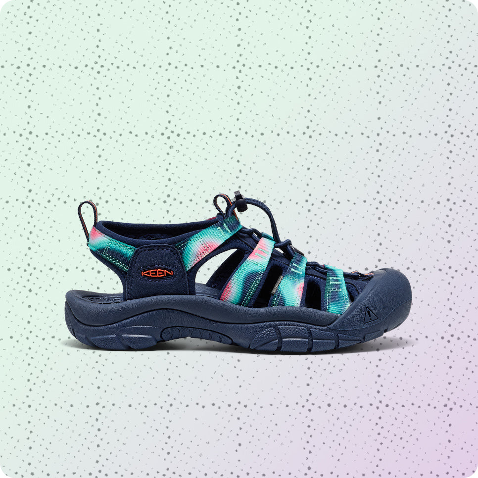 Womens navy blue and tie-dye Newport water sandal on a dotted grid wrapping-paper background.