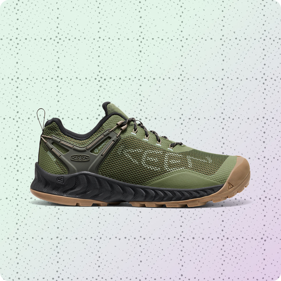 Men's green, lightweight and waterproof hiking shoe on a dotted grid wrapping-paper background.