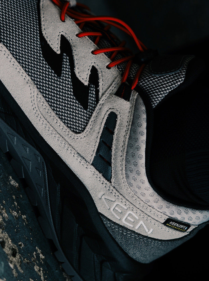 Product shot of Bal and Keen collaboration Hightrail shoe showcasing red bungee laces. 