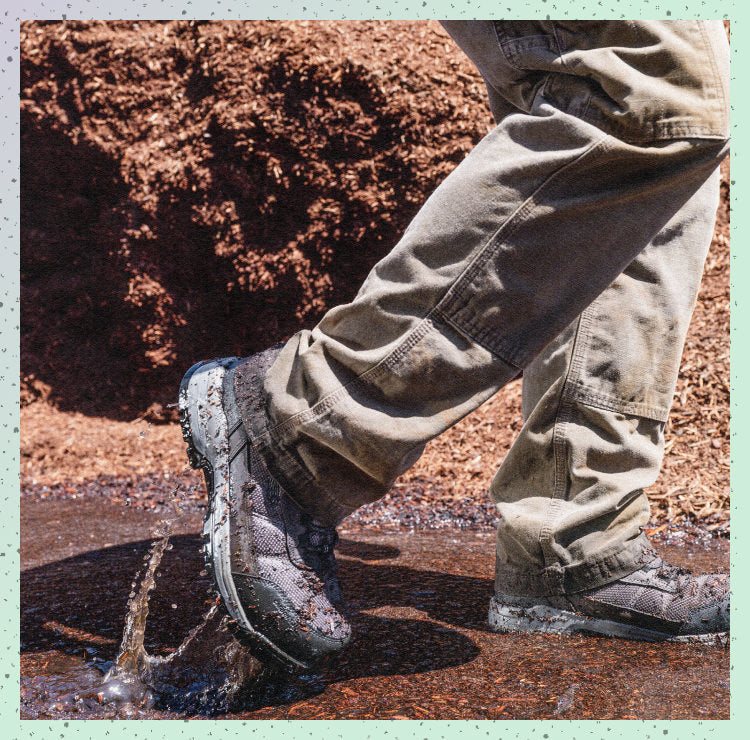 Man walking through mud wearing Skokie work boots